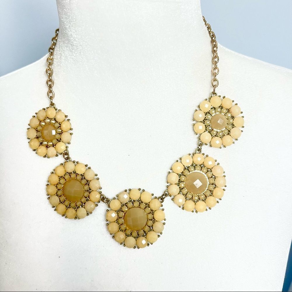 Jewel medallion floral pendant necklace on a gold tone chain